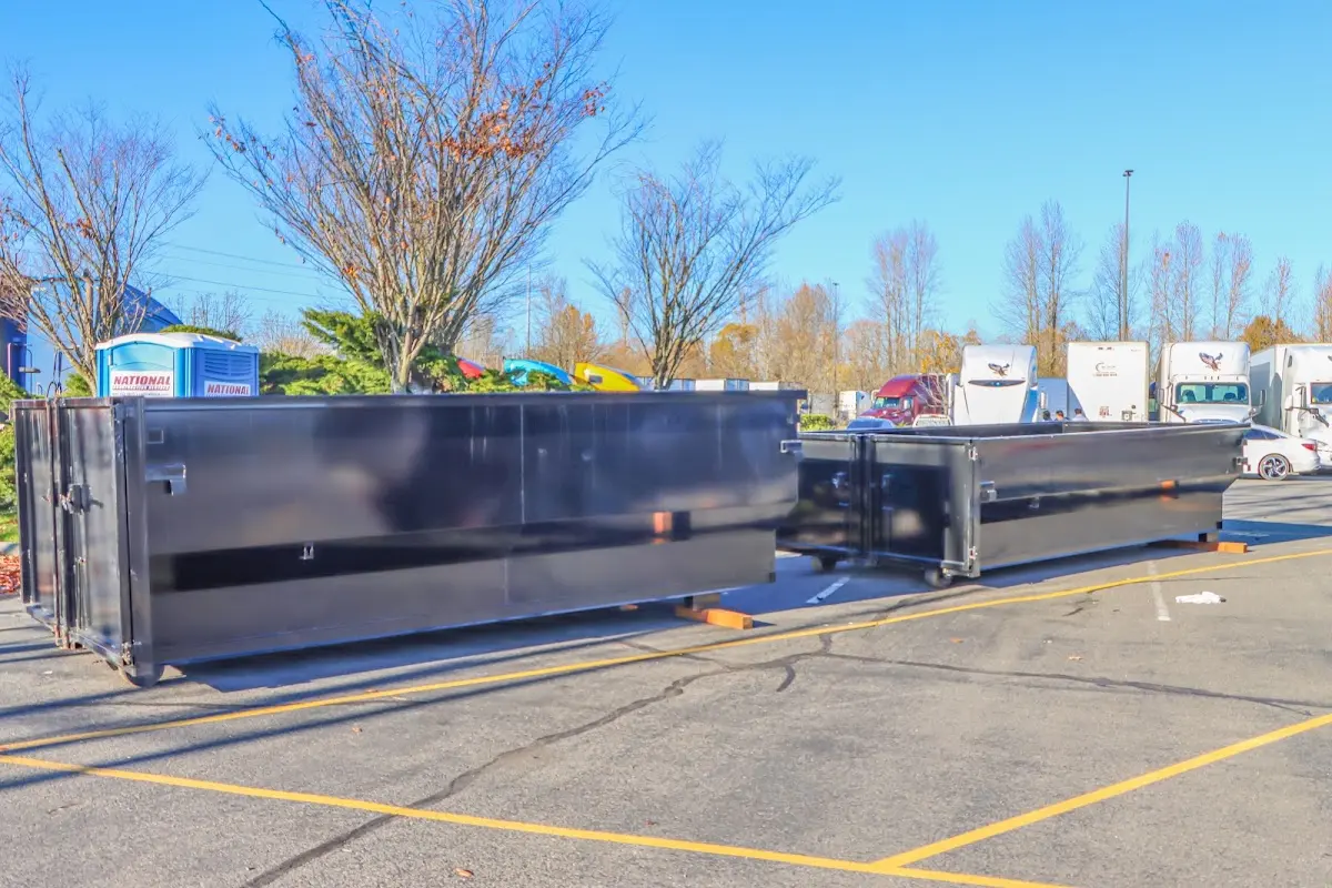 Professional dumpster rental service with roll-off container on residential driveway in Roxborough Park